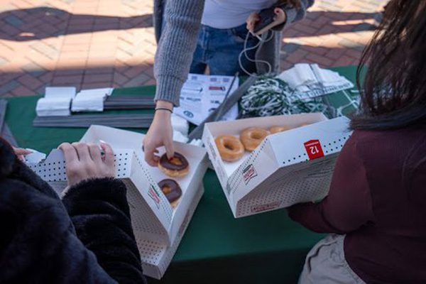 Students handing out donuts