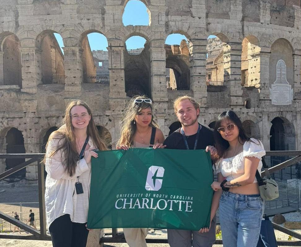 Students posing in front of the coliseum