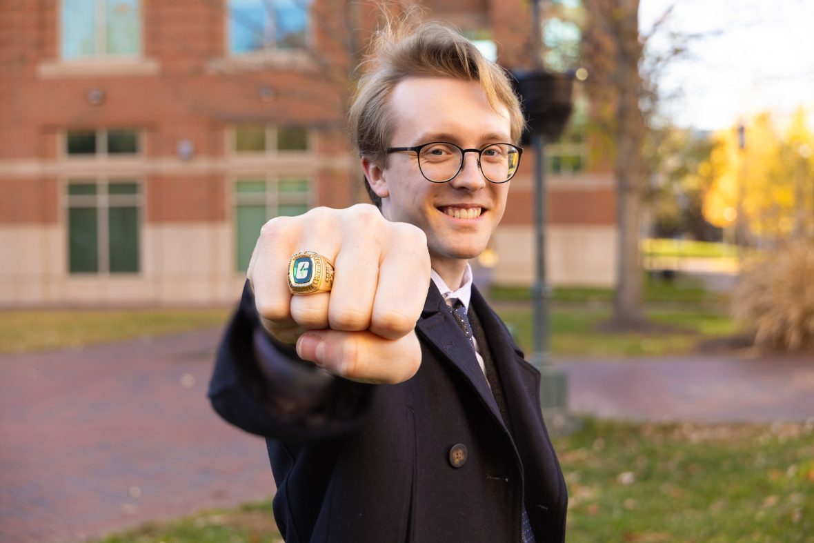 Student smiling displaying his new class ring from UNC Charlotte