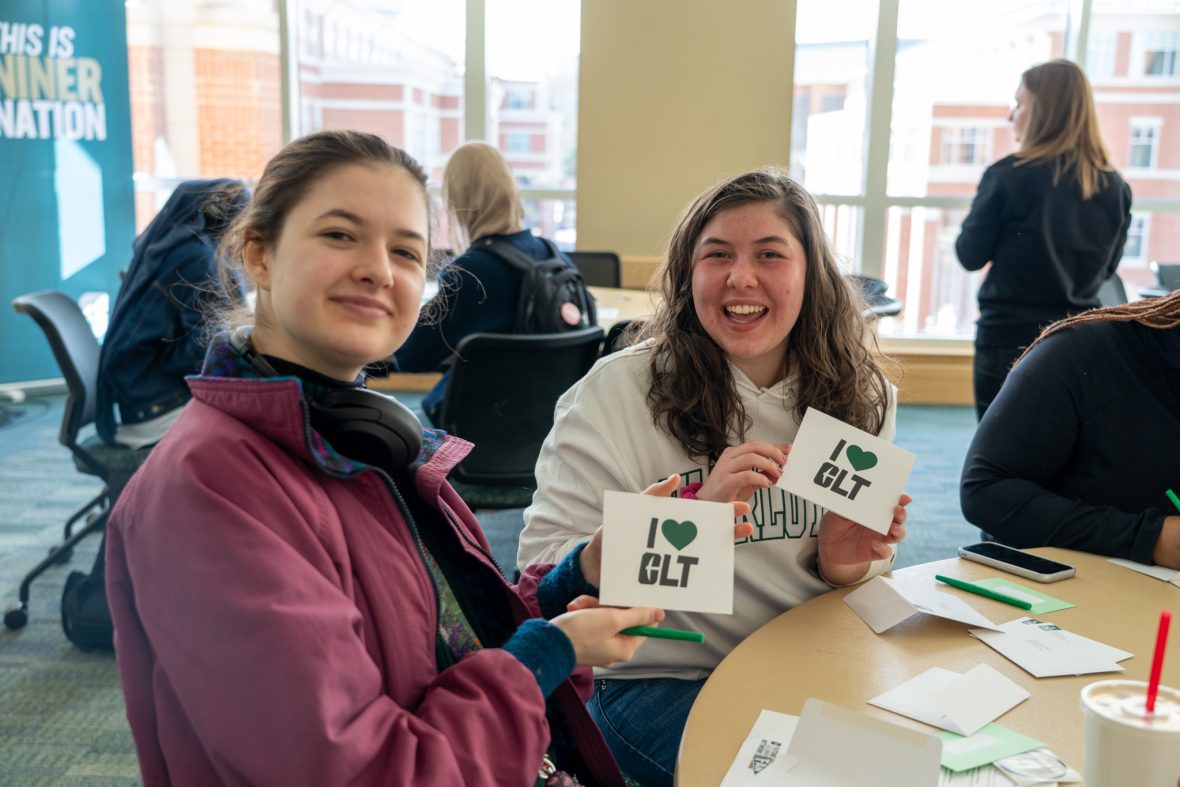 Students writing I heart CLT cards